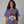 Woman wearing a purple t-shirt with a tequila-themed graphic on a gray background