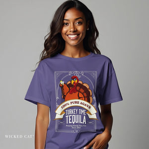 Woman wearing a purple t-shirt with a tequila-themed graphic on a gray background