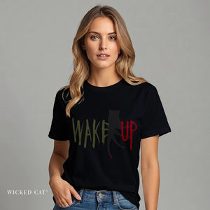 Woman wearing a black t-shirt with 'WAKE UP' text, standing against a gray background.