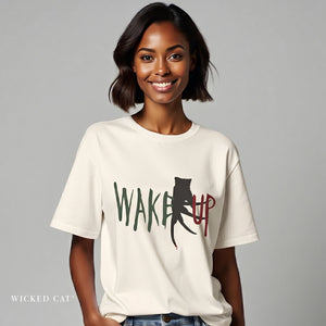 Woman wearing beige t-shirt with Halloween graphic that says "Wake Up"