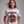 Woman wearing a white July 4th funny t-shirt with a graphic design and text, on a plain background.