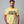 Man wearing a beige t-shirt with 'IT NEEDS MORE POWER' text on a gray background