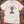 t-shirt with a cartoon cat tangled in Christmas lights with text at the top that says I Regret Nothing, laying on a wood floor with christmas lights around it.