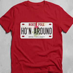 Red t-shirt with graphic of a license plate from the North Pole that says HO'IN AROUND Keeping it nice & naughty