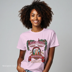 Woman wearing a pink t-shirt with a Christmas-themed graphic and text.