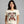 Woman wearing a t-shirt with a festive design of a woman and text on a gray background