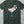 Green t-shirt with festive graphic of a margarita glass with a santa hat on top