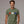 Man wearing a green t-shirt with colorful paw prints on a gray background
