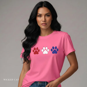 Woman wearing a pink t-shirt with colorful paw prints on a gray background