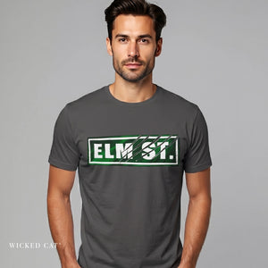 Man wearing a gray t-shirt with 'ELM ST.' print on a gray background