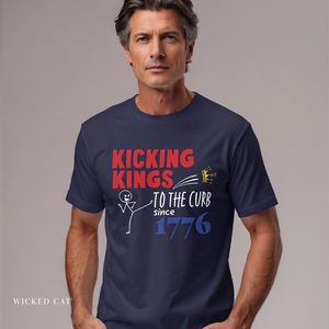 Man wearing a navy blue  patriotic t-shirt with a graphic and text Kicking Kings to the Curb since 1776 on a gray background