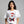 Person wearing a white t-shirt with a Santa Claus graphic and mugshot design.