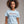 model wearing patriotic t-shirt with embroidered quote Proud to Care Love Give Be an American