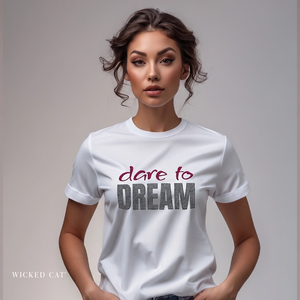 Woman wearing a white t-shirt with 'dare to DREAM' text on a plain background