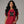 Woman wearing a red t-shirt with 'Generation X' embroidered on it against a gray background