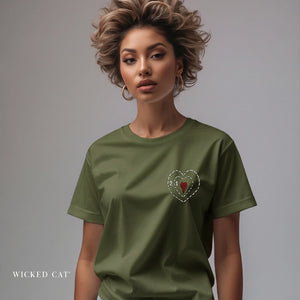 Woman wearing a green t-shirt with a heart design on a gray background