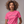 Woman wearing a pink t-shirt with 'Sip Sip Hooray' text on a plain background