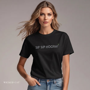 Woman wearing a black t-shirt with 'SIP SIP Hooray' text, standing against a plain background.