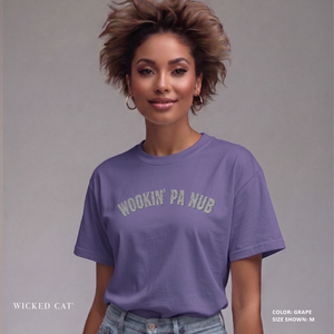 Woman wearing a purple t-shirt with text, standing against a plain background