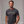 Man wearing a dark gray t-shirt with 'Wookin' Pa Nub' text on a plain background