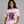 Woman wearing a pink t-shirt with a graphic design and text 'Follow Your Dreams' on a gray background.
