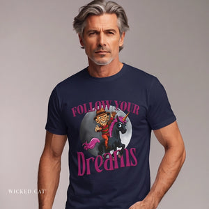 Man wearing a navy blue t-shirt with a graphic design and text 'Follow Your Dreams' on a plain background.