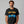 Man wearing a black t-shirt with 'Gone Fishing' graphic design on a gray background