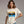 Woman wearing a 'Gone Fishing' t-shirt with a graphic design on a plain background