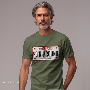 Man wearing a green t-shirt with a humorous holiday license plate design on a plain background