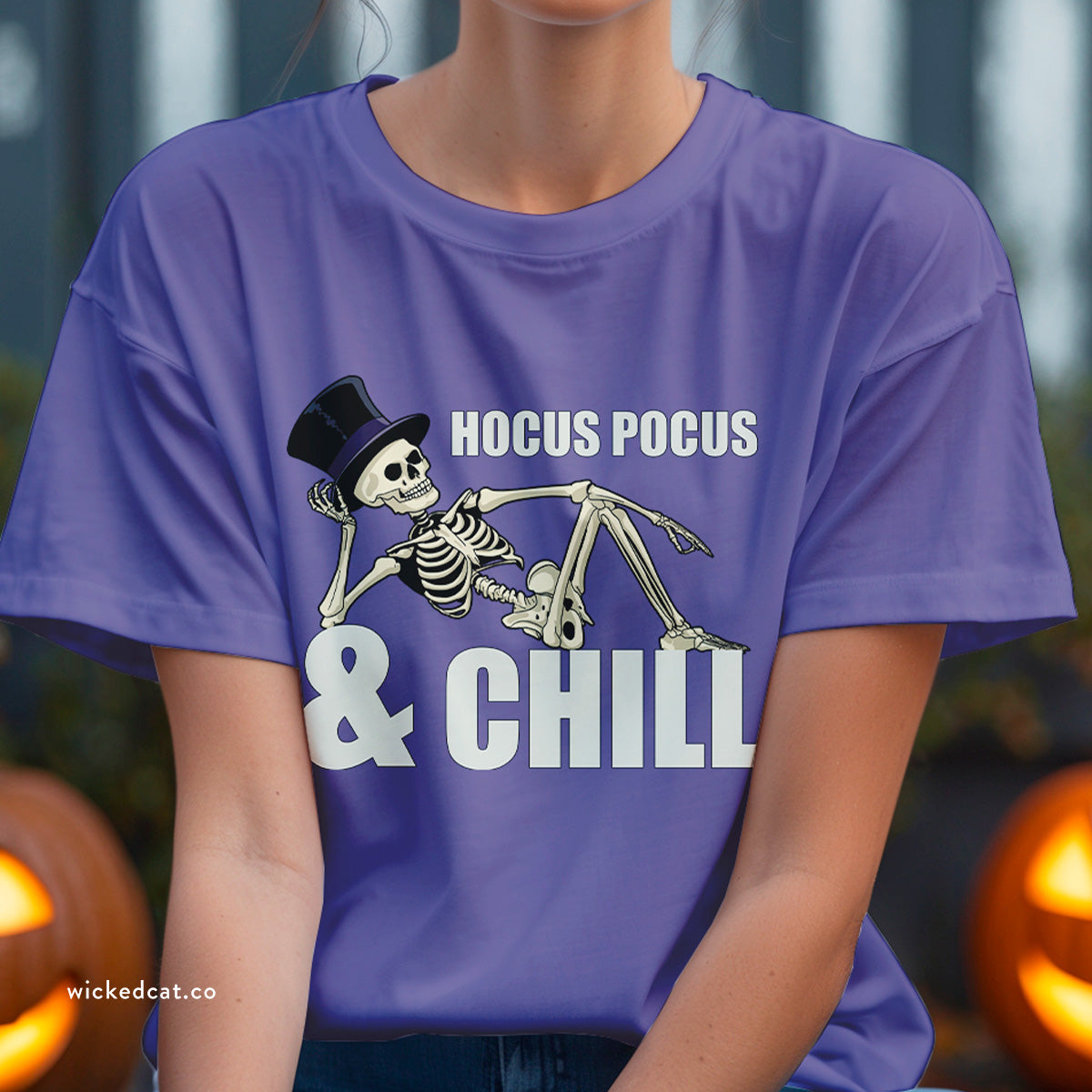 Purple t-shirt with skeleton design and 'HOCUS POCUS & CHILL' text on a white background