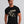 Person wearing a Boysenberry t-shirt with 'Horror Flix & Chill Skeleton Halloween' design on a plain background