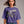 Person wearing a black t-shirt with 'Horror Flix & Chill Skeleton Halloween' design on a plain background