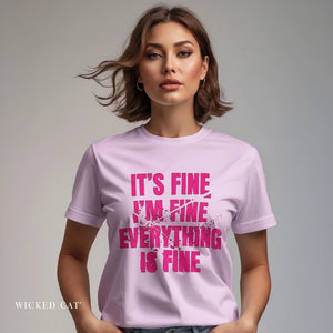 Woman wearing a light purple t-shirt with pink text on a plain background