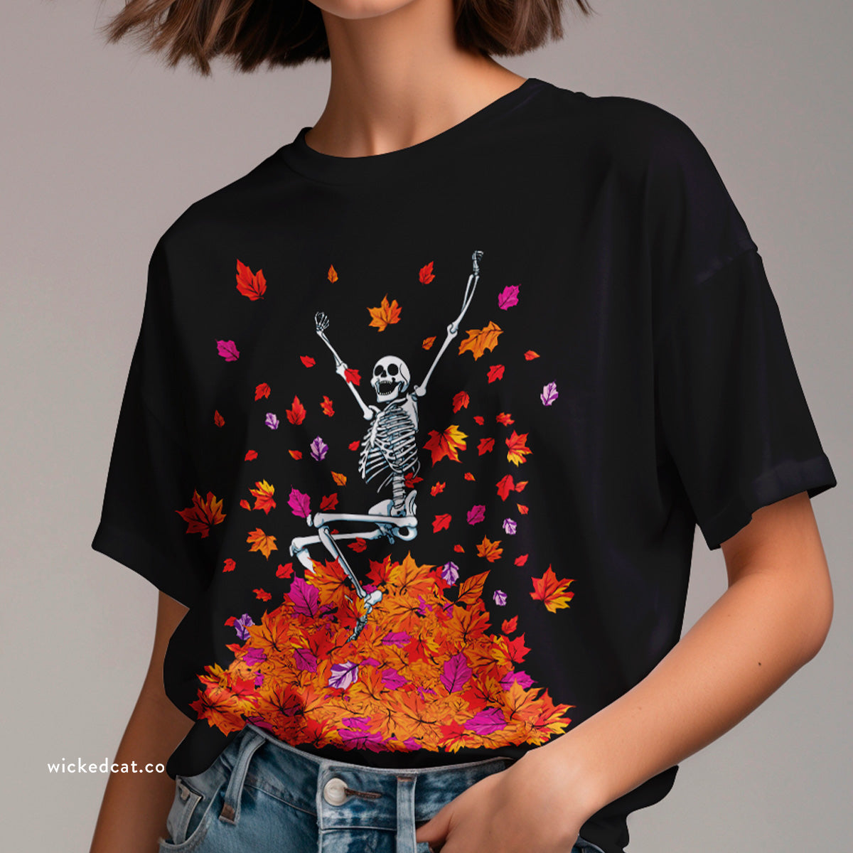 Black t-shirt with a skeleton and colorful leaves design on a white background