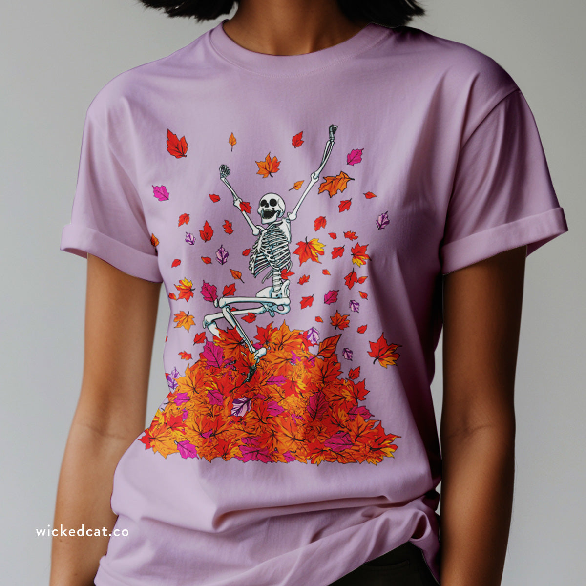 Black t-shirt with a skeleton and colorful leaves design on a white background