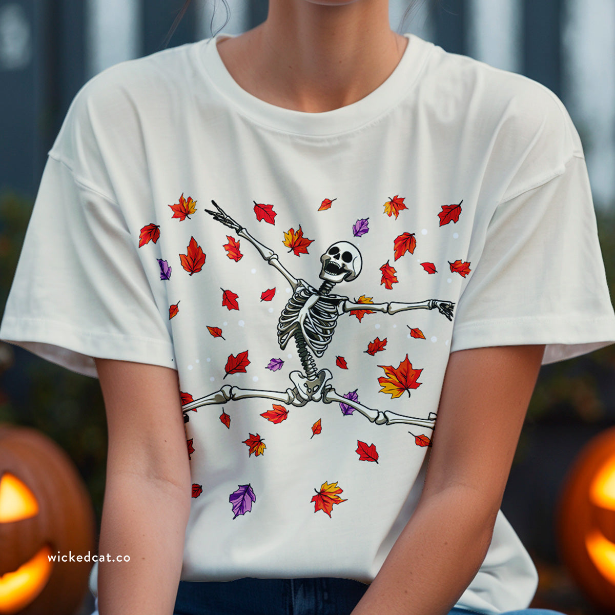 Beige Halloween t-shirt with a skeleton and leaf design on a white background