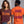 Two models wearing graphic t-shirts from the brand Wicked Cat. The left model shows a maroon short-sleeve t-shirt with 'START JUMPING' printed in orange.