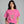 A woman wearing a bright pink t-shirt with a graphic of a skeleton hand making a rock on sign, set against a solid gray background. The brand name 'WICKED CAT' is visible in the bottom left corner.