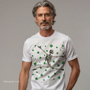 Man wearing a white t-shirt with a skeleton and shamrock design on a gray background