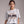 women wearing white t-shirt with Welcome to Never Never Land Start Jumping text on the front.