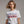 Person wearing a white t-shirt with 'Vote Alien Invasion 2028' text on a plain background