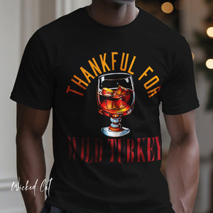 Person wearing a pink t-shirt with 'Wild Turkey Funny Holiday' design on a plain background
