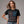 Person wearing a dark gray t-shirt with 'Martini American Patriotic July 4th' design on a plain background