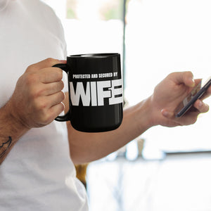 mug with 'Protected By Wife Funny Husband Gift' graphic on a white background