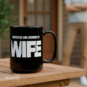 mug with 'Protected By Wife Funny Husband Gift' graphic on a white background