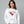 Woman wearing a white sweatshirt with 'Merry Martini' design on a gray background