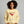 Woman wearing a beige sweatshirt with 'Merry Martini' design on a gray background