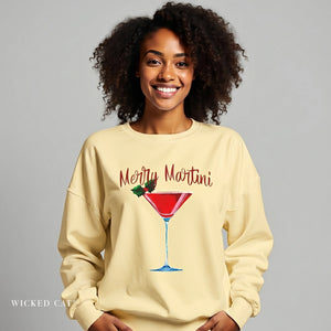 Woman wearing a beige sweatshirt with 'Merry Martini' design on a gray background