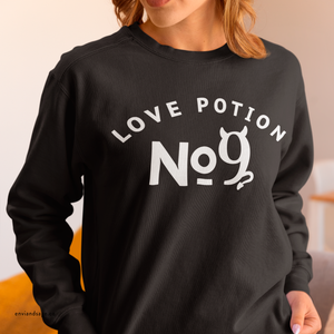 Yellow sweatshirt with 'Love Potion No 9 Halloween' design on a plain background