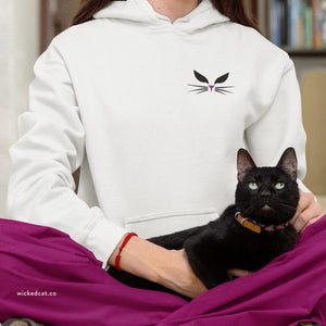 Light pink hoodie with embroidered 'Wicked Cat® Embroidered' design on a plain background